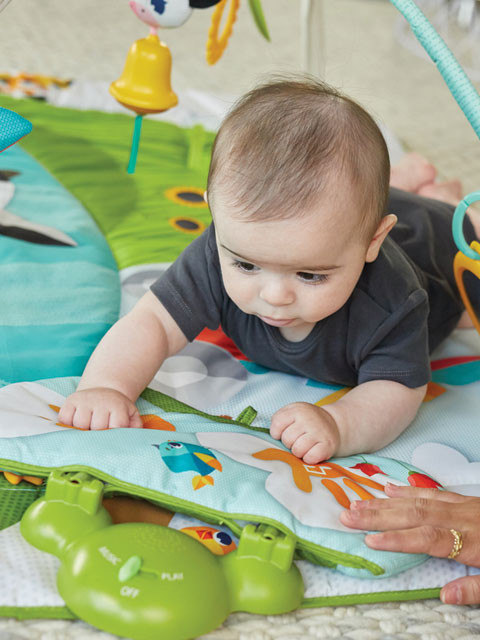 Baby -activated tapping pad for extended tummy time fun