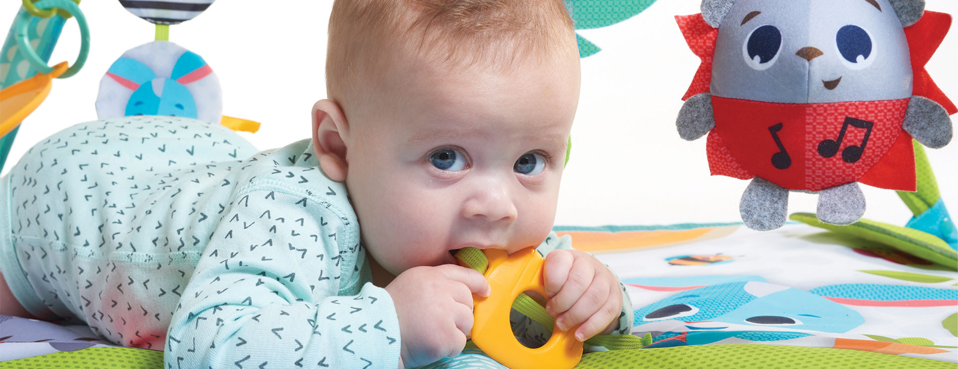 Carrot shape teether and other attached toys stimulate the senses