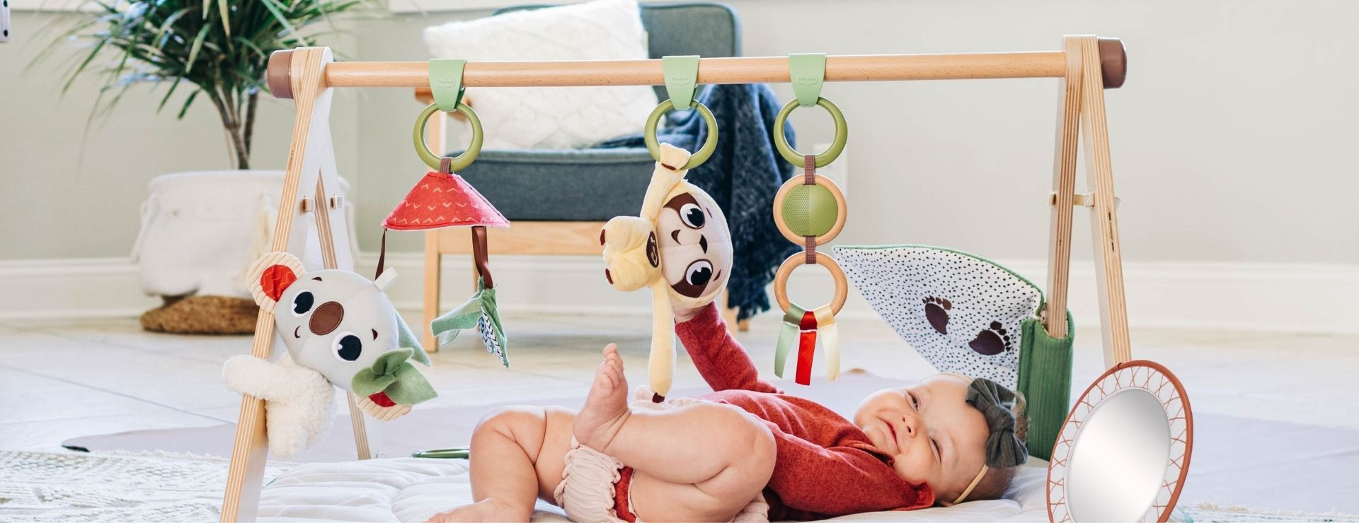 Boho style developmental baby gym with a wooden stand alone arch